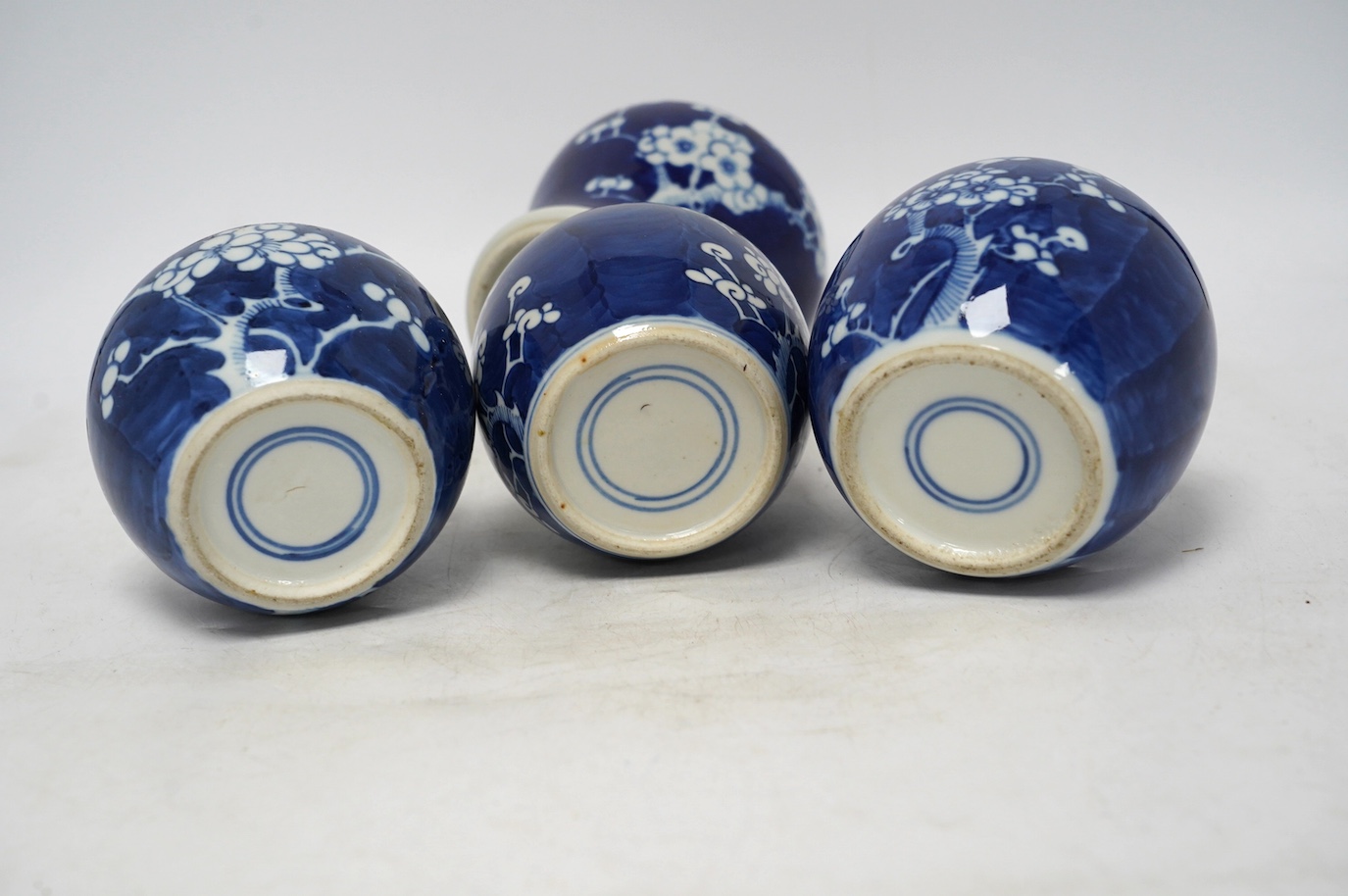 Three Chinese blue and white prunus jars and a similar vase and cover, early 20th century, vase 16.5cm high. Condition - poor as all three jars have the covers missing